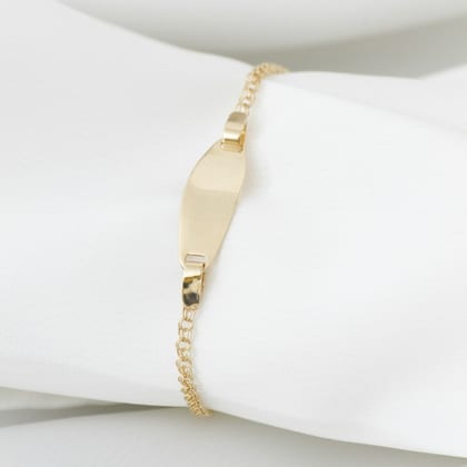 Fine gold chain bracelet with a small curved ID plate, on white cloth