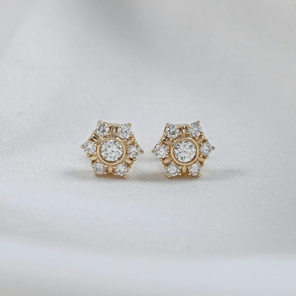 Pair of hexagonal diamond stud earrings on white