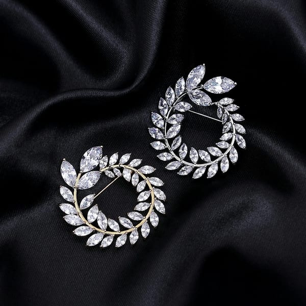 White gold earrings shaped as wreaths of marquise diamonds, on black satin