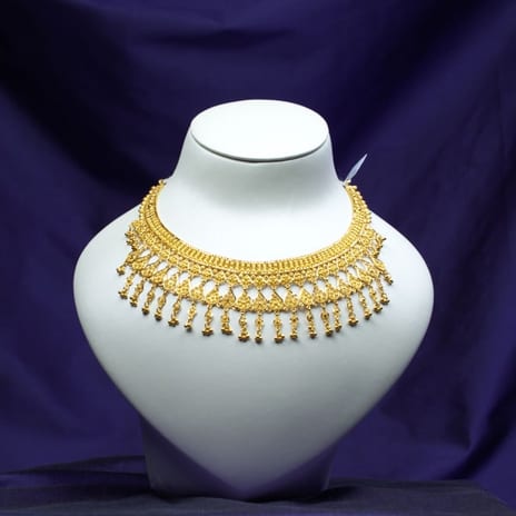 Antique-finish 22K gold bib necklace edged with pearl drops on a white bust