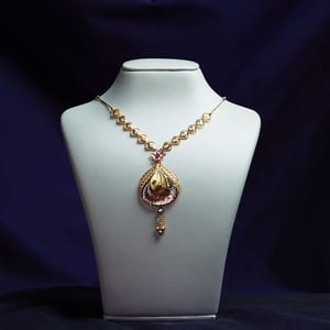 Custom-made 22K gold bridal necklace on a white bust