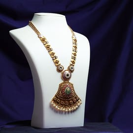 22K gold temple-style long necklace with a large bell pendant on a white bust