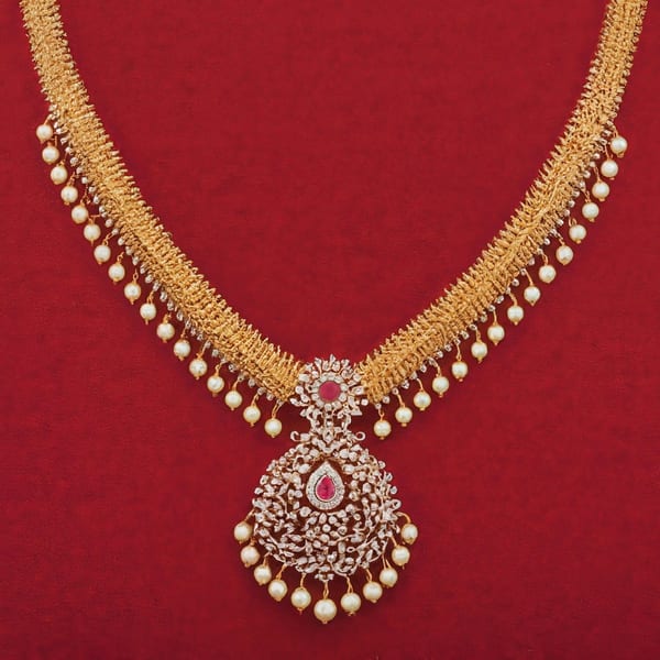 Gold necklace edged with pearls, with a ruby-centred pendant, on red cloth